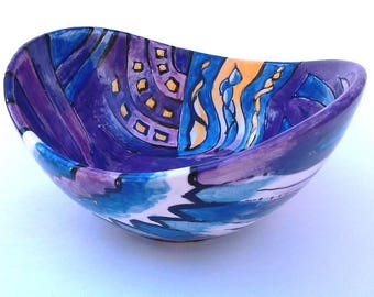 Hand painted small ceramic "swoop" bowl in purples, blues and orange