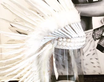 A Feathered headdress with shell detail