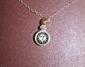 Silver necklace with pale moon and coloured sun pendant. Chain is 8 inches (21 cm) in length.