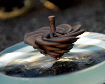 The Tornado Top - Air powered spinning top that spins faster as you blow on it