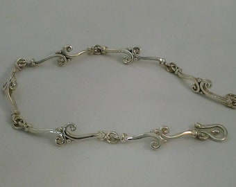 Sterling silver custom link bracelet.