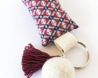 Key ring in fabric decorated with hand-stitching and pendants