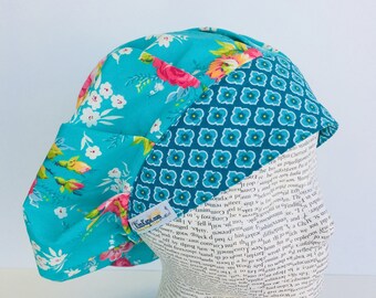 Traditional Bouffant Scrub Cap scrub hat featuring a blue material with flowers in pink green and white with a coordinating band 2t