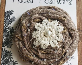 Burlap ribbon rose accented with a doily, pearl center and glass seed beads