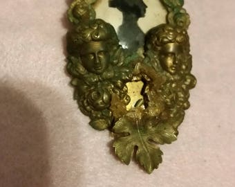 Odd brass with paper silhouette brooch