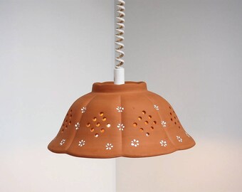 Lovely unglazed pottery pendant with white flower decorations - vintage design from 1970s