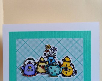 Teapots with a teal background
