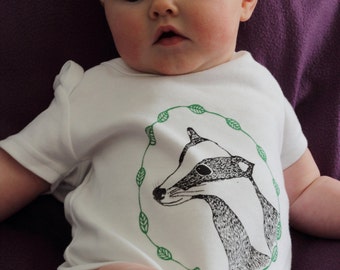 Organic Badger Baby grow, hand screen printed with eco-friendly inks. Featuring 'Betty the Badger' in a circle of leaves.