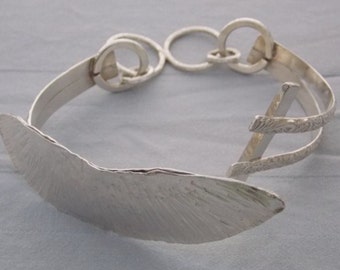 Fine and sterling tension bracelet
