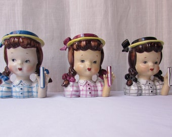 THREE 1950S HEAD VASES Girls with pigtails. Blue pink black dresses