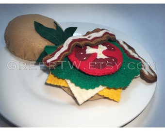 BLT on a bun ,felt bacon lettuce tomato with white and yellow cheese sandwich,