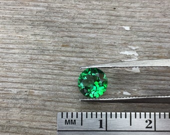 One 6mm faceted "Rainforest" green topaz semiprecious gemstone