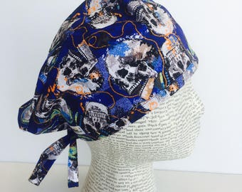 Men's Scrub Cap scrub hat featuring a dark blue material with skeleton heads with headphones