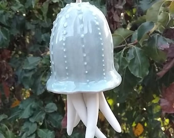 Light blue jellyfish wind chime. Ceramic wind chimes, white dot sea urchin. Hanging jellyfish installation.
