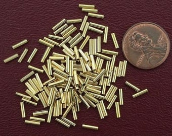 one hundred twenty 6mm gold plated tube beads