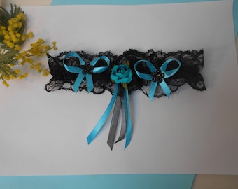 Black and turquoise garter with artificial rose