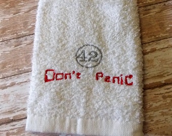 Don't panic, carry a Hand towel. 42, the meaning of life, universe and everything. HGTG, Towel Day, Hitchhikers Guide by Douglas Adams.