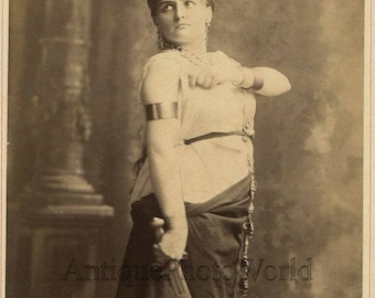 Isabelle Urquhart actress singer with dagger antique cabinet photo