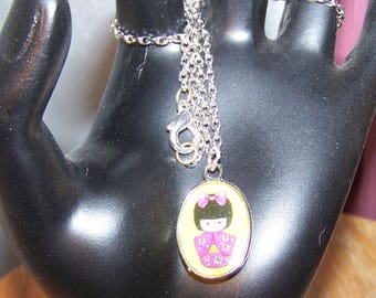 Necklace little Japanese gheisha on yellow background