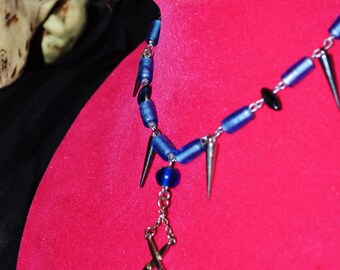 blue beaded necklace with skull and switchblade pendant