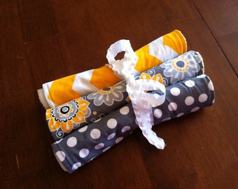 Grey and yellow terry cloth burp cloths.