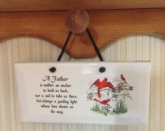 Ceramic Plaque it is 3 by 6. With A father saying