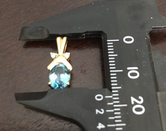 14ky sold gold blue topaz /diamond pendant