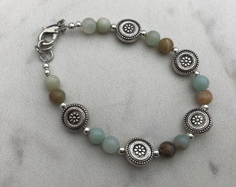 Single strand bracelet with round silver accents