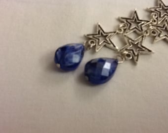 Dazzling 4" star earrings with sparkling, faceted blue stones