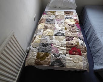 Patchwork quilt, multi-coloured blocks of samples of furnishing fabric. Floral fabric. 104 cm x 140cm. Lap quilt or single bed topper.