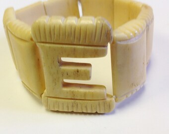 Vintage, hand carved, bone panel stretch bracelet. Bone cuff carved with letter E.