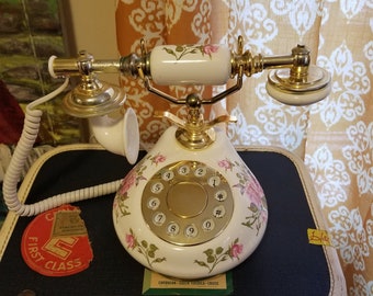 Vintage style push button telephone with floral detail.