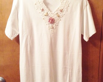 V neck T shirt with embellishments.