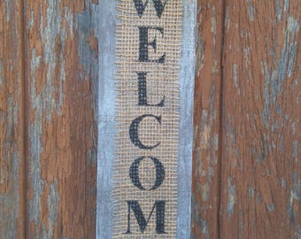 Wooden door sign and burlap Welcome basalt