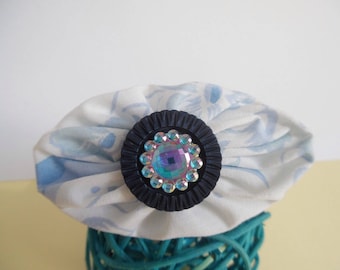 Oval fabric and blue rhinestone brooch