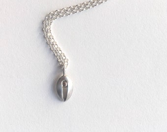 Silver and gold tiny contemporary vulva pendant.