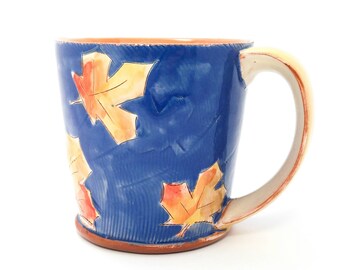 Blue puffy maple leaf themed Earthenware mug. Wheel thrown, food safe leafy mug made by Kaitlyn Brennan / Brennan Pottery