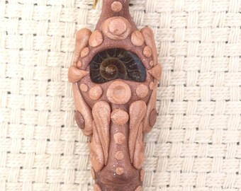 Polymer clay necklace pendant with ammonite (alien face)
