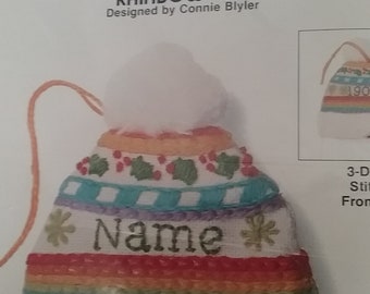 1980s Jiffy Stitchery Christmas Rainbow Cap. New old stock Package