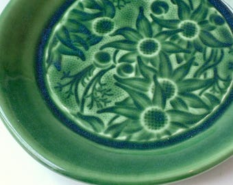 Deep green ceramic plate with Australian Flannel Flowers