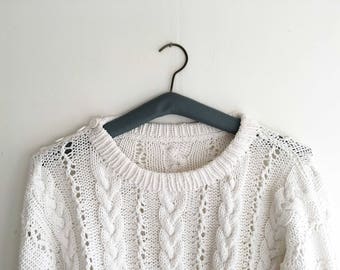 Hand-knitted vintage white cable sweater with button fastening on shoulder