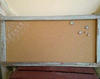 Repurposed vintage antique window frame with corkboard and small hooks for keys