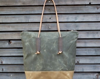 Waxed canvas tote bag with leather handles and zipper closure