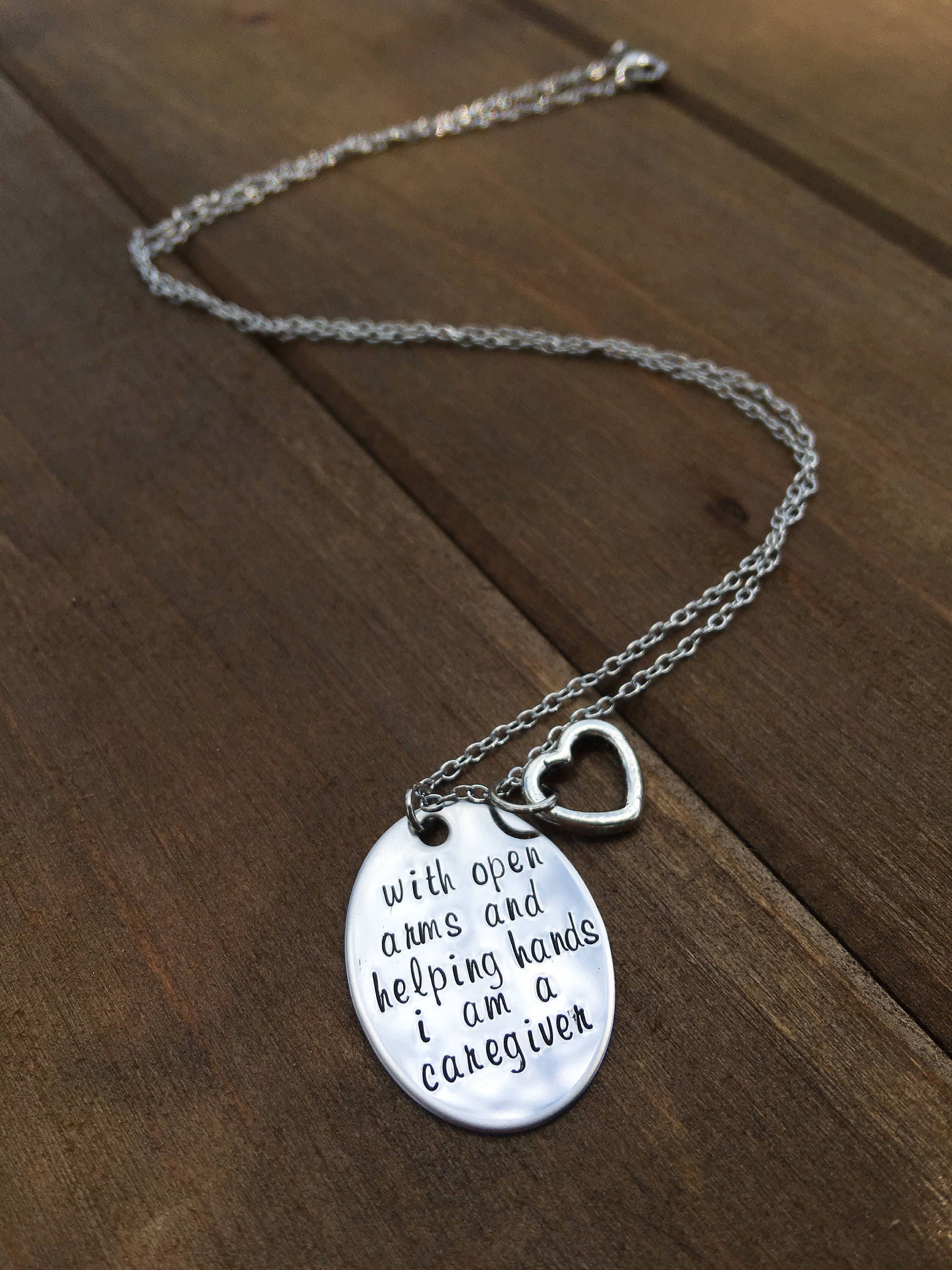 with open arms and helping hands i am a caregiver necklace