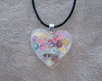 Pretty little handmade resin heart charm necklace with tiny butterflies, dragonflies, petals and glitter