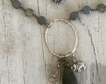 Loyal. Small labradorite coin chain suspend a hand-forged oval with a labradorite briolette, fine silver elephant and sitting Buddha charm.