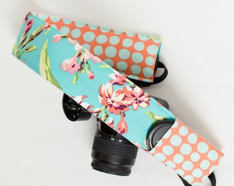 DSLR camera strap cover with lens cap pocket. Teal and tangerine floral and dot.