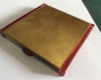 REES CREATIONS.English made 1920s art deco period lucite powder compact unused...4 inches square.