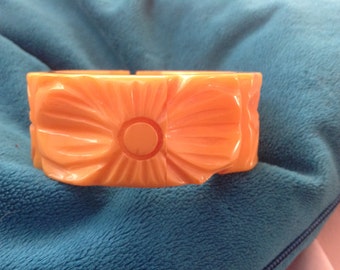 Vintage carved butterscotch Bakelite clamper bracelet with floral design