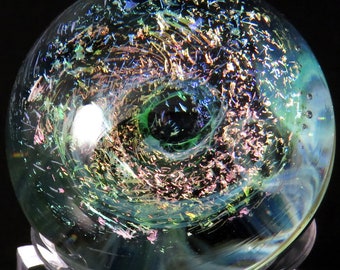 Multicoloured copper with green mist spiral galaxy over a nebula glass marble - collectable handmade space marble glass artwork